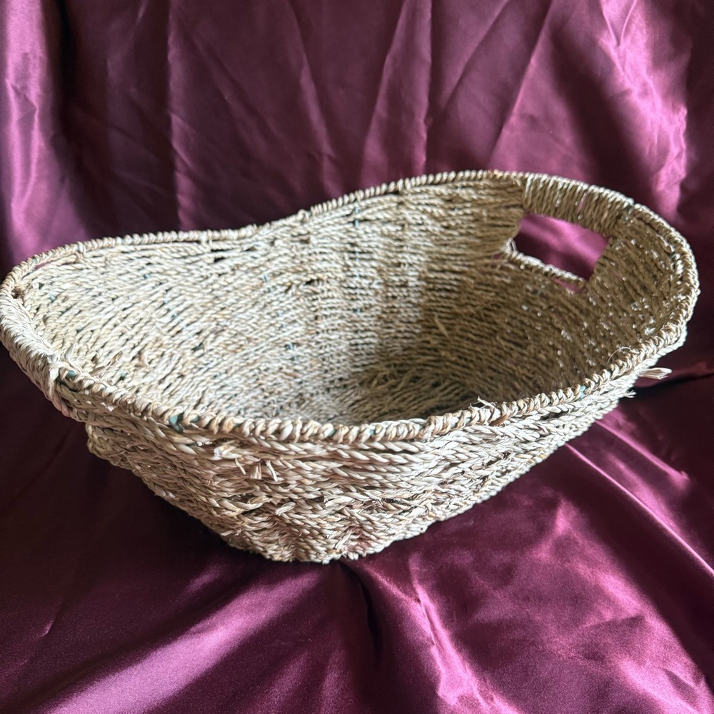 Woven Seagrass Oval Basket with handles and wire frame.